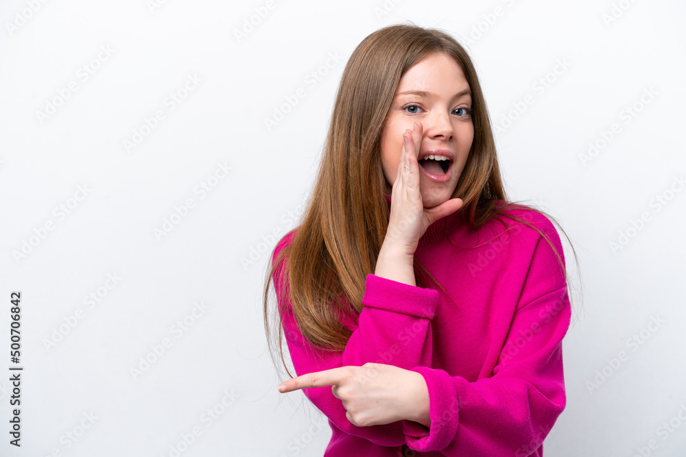 Young caucasian woman isolated on white background pointing to the side to present a product and whispering something Young caucasian woman isolated on white background pointing to the side to present a product and whispering something