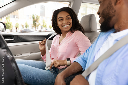 Happy African American Couple Putting On Seatbelts photo