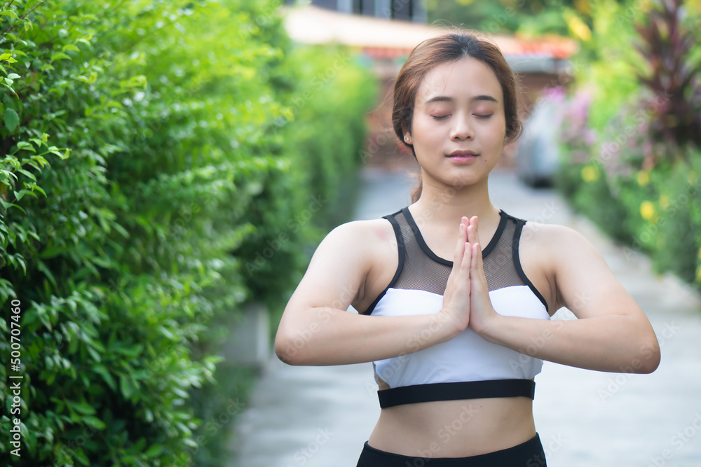 Woman practicing Traditional yoga Surya namaskar or sun salutation pose series in city park, concept of self care, health care, mindfulness, wellness Woman practicing Traditional yoga Surya namaskar or sun salutation pose series in city park, concept of self care, health care, mindfulness, wellness