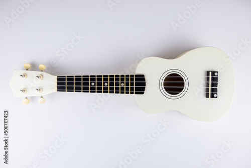 strings of a beautiful white guitar close-up on a white background ukulele