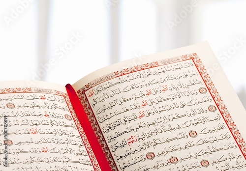 Opened Quran book for Muslim to recites as a devotion to God. photo