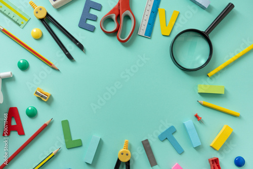 Different stationery on green table background, flat lay. Space for text, back to school concept