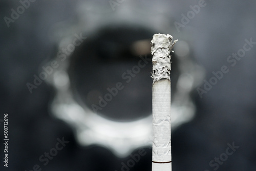 close up of burning cigarette on dark background 