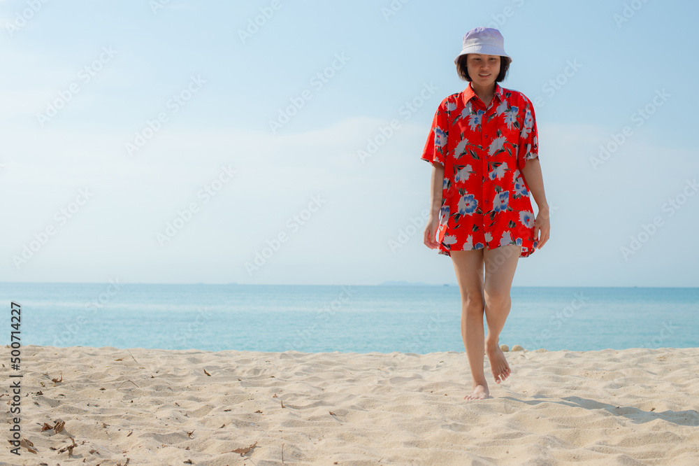 Portrait beautiful young asian woman relax walking leisure around sea beach ocean with white cloud on blue sky in travel vacation