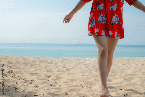 Portrait beautiful young asian woman relax walking leisure around sea beach ocean with white cloud on blue sky in travel vacation