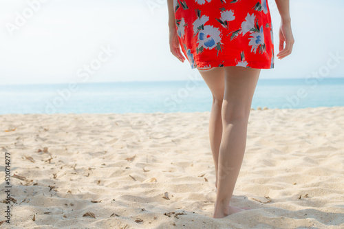 Portrait beautiful young asian woman relax walking leisure around sea beach ocean with white cloud on blue sky in travel vacation