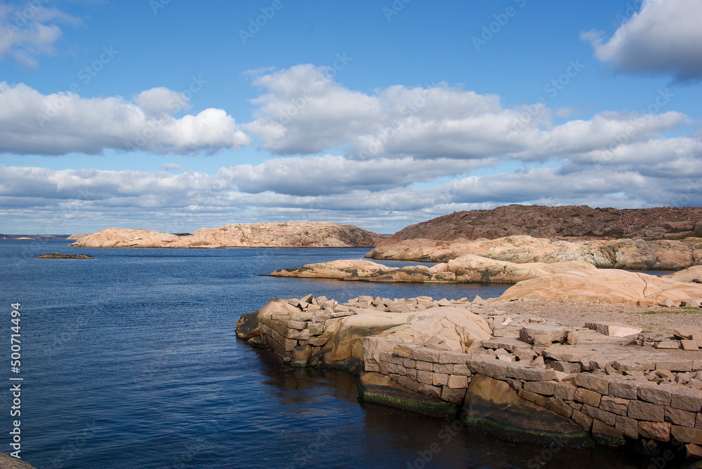 Seascape with red granite boulders and blue summer sky at the swedish west coast.