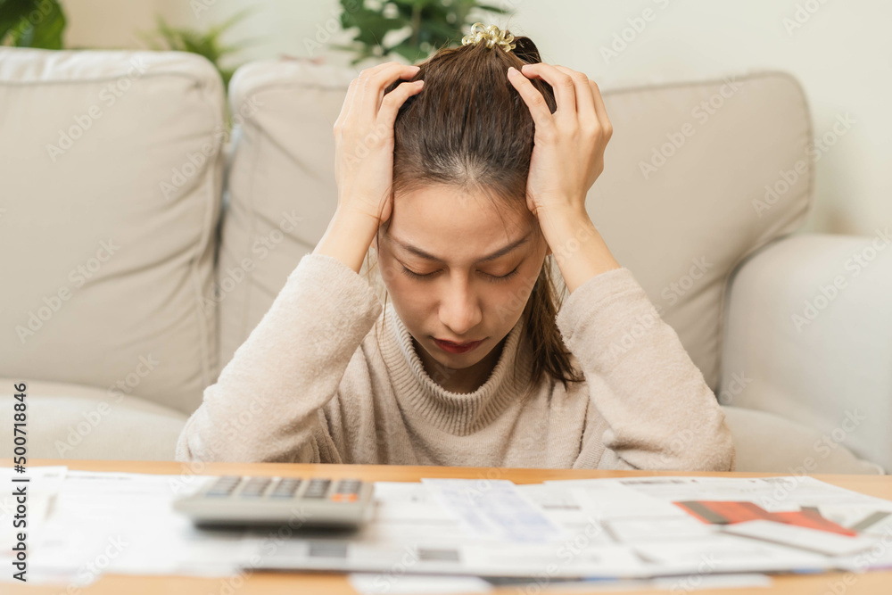 Financial owe asian young woman, girl sitting suffer, stressed and confused by calculate expense from invoice or bill, have no money to pay, mortgage or loan. Debt, bankruptcy or bankruptcy concept. Financial owe asian young woman, girl sitting suffer, stressed and confused by calculate expense from invoice or bill, have no money to pay, mortgage or loan. Debt, bankruptcy or bankruptcy concept.