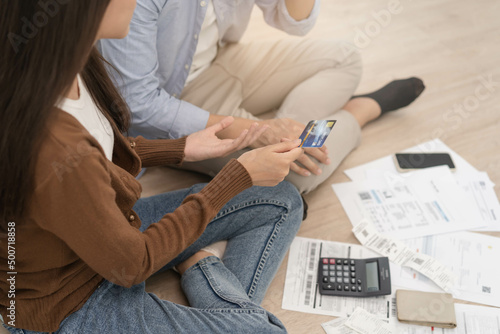 Stressed financial owe asian young couple love sitting suffer, stressed and confused by calculate expense from invoice or bill, no money to pay, mortgage or loan. Debt, bankrupt or bankruptcy people.