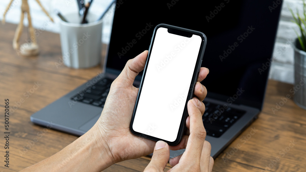 Hands of a businessman using a  smartphone mockup at his desk, Mobile phone blank screen for editing graphics.