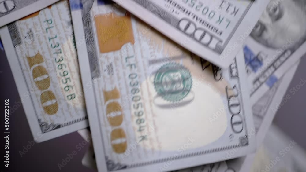 A Lot of Falling, Flying 100-Dollar American Banknotes on a Blurred Background. Money rain. Wealth, spending, jackpot, lottery. Finance, success, wealth, capital. Throw money. Slow motion. Close up. A Lot of Falling, Flying 100-Dollar American Banknotes on a Blurred Background. Money rain. Wealth, spending, jackpot, lottery. Finance, success, wealth, capital. Throw money. Slow motion. Close up.