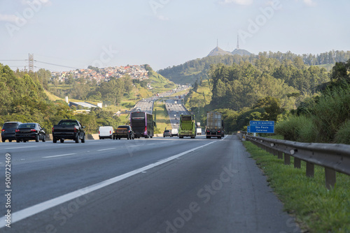 vehicle traffic on the Bandeirantes highway towards the city of São Paulo, border with the city of Caieiras, SP, Brazil, Pico do Jaraguá in the background photo