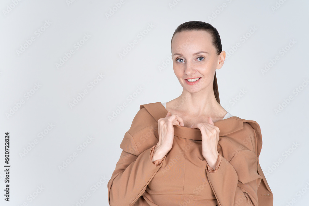 Cheerful smiling woman jokingly put on a jacket in reverse. Looks playfully at the camera. Banner for advertising and articles with copy space Cheerful smiling woman jokingly put on a jacket in reverse. Looks playfully at the camera. Banner for advertising and articles with copy space