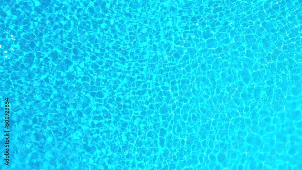 Blue water in the swimming pool with light reflections. Aerial footage Blue water in the swimming pool with light reflections. Aerial footage