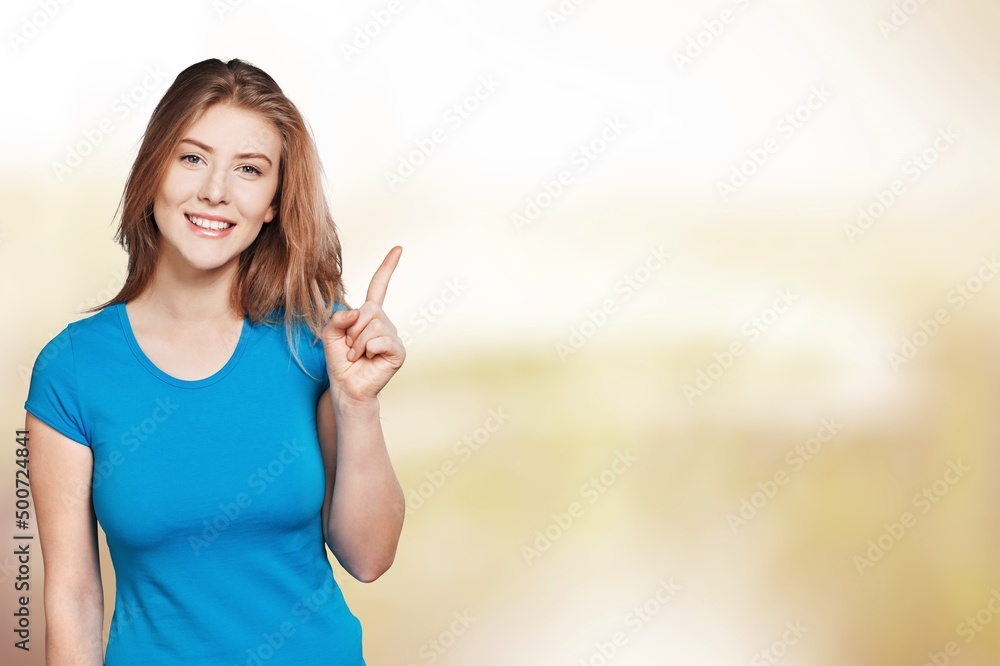 Cheerful girl demonstrating copy empty space ad advert on abstract background Cheerful girl demonstrating copy empty space ad advert on abstract background