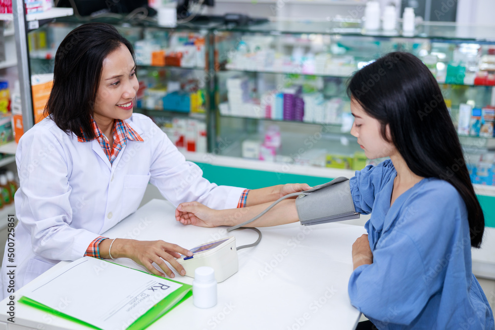 Doctor female Measuring arterial blood pressure young woman patient in clinic