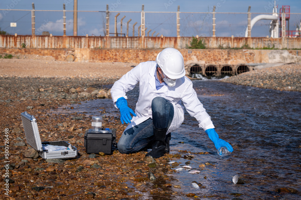 Scientist wearing safety uniform and glove under working water analysis and waste water quality to check case in laboratory is environment pollution problem concept. Scientist wearing safety uniform and glove under working water analysis and waste water quality to check case in laboratory is environment pollution problem concept.