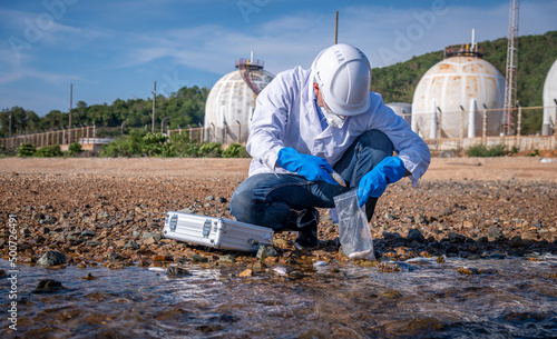 Scientist wearing safety uniform and glove under working water analysis and waste water quality to check case in laboratory is environment pollution problem concept.
