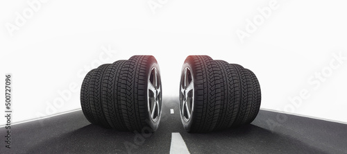  Car tires standing on the road against sun light of headlights in spring. photo