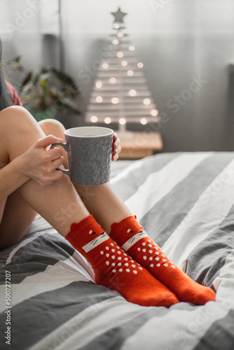 drinking a cup of tea in fox socks at Christmas in winter at home