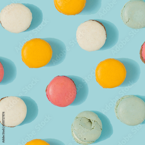 Pastel blue table top with colorful macarons pattern. Minimal sweet food concept. Cookie concept.
