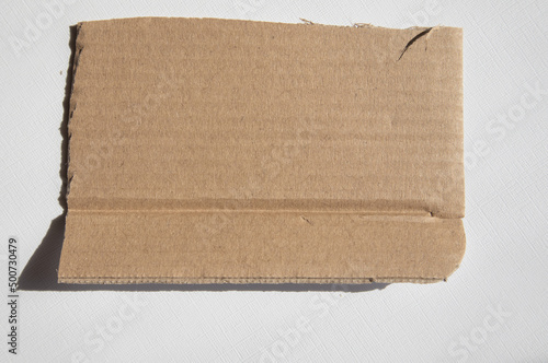 Wallpaper Mural A torn piece of kraft cardboard on a white background. Template, place for text Torontodigital.ca