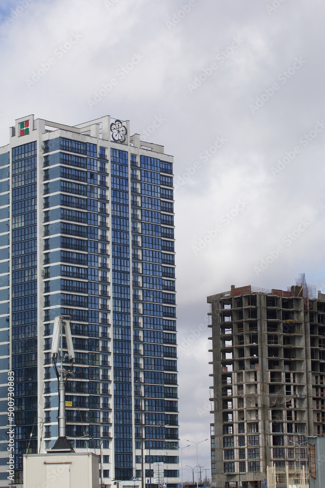 Fototapeta premium Construction of multi-storey buildings. Modern multi-storey building. Completed and under construction buildings.