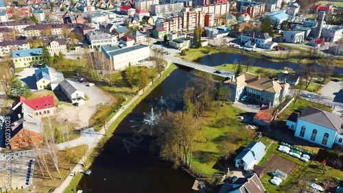 Aerial Shot of Birzai Castle, Fortress Birzai - a Castle in Birzai, on the Southern Coast of the Lake Širvėna in Lithuania, Sunny Spring Day. Historic Beautiful Church and Birzai City Panorama 4K UHD  photo