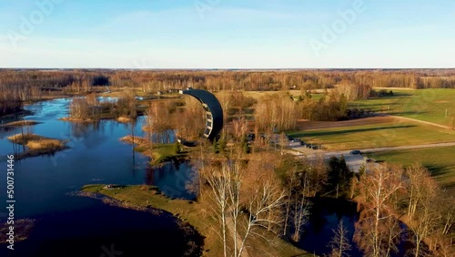 Modern Construction Observation Tower in Kirkilai. Green Nature With Pond in Sunset at Birzai Eldership, Panevezys County, Lithuania. 4K UHD Amazing Aerial Dron Shot
 photo