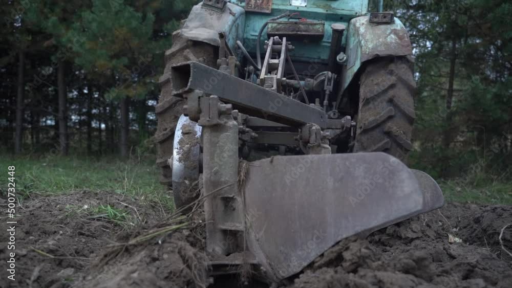 selective focus. a peasant plows the land on a tractor selective focus. a peasant plows the land on a tractor