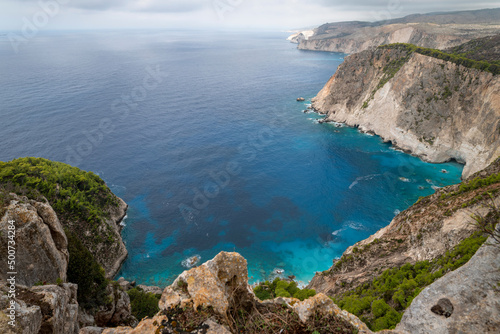 Famous cliff rock, sea, celar blue water, nature in Zakynthos Ionian island, Greece. Amazing view with multicolored clouds, clear sky. Island of lovers. Doors to heaven.