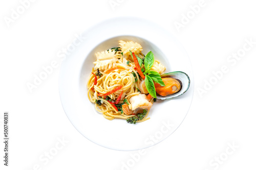 Top view of plate with spaghetti in tomato sauce and basil on white background.Tasty pasta with shrimps,mushroom Sea food.