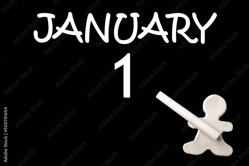 A small white plasticine man writing the date 1 January on a black board. Business concept. Education concept. A small white plasticine man writing the date 1 January on a black board. Business concept. Education concept.