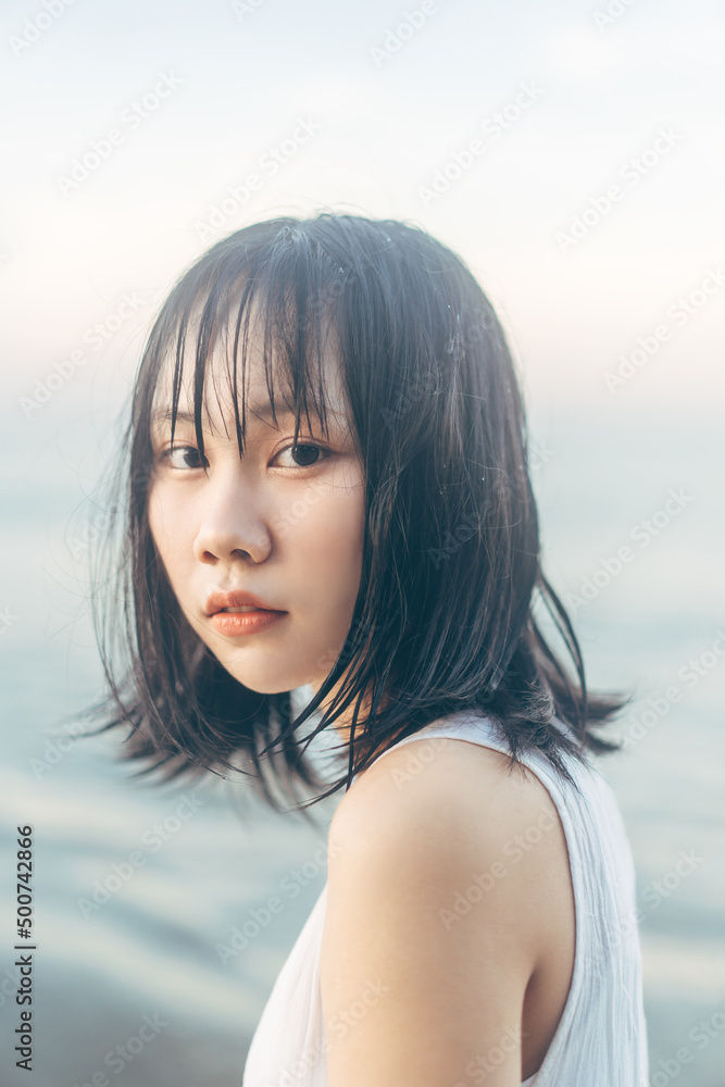 Portrait of asian woman at the beach with wet hair.