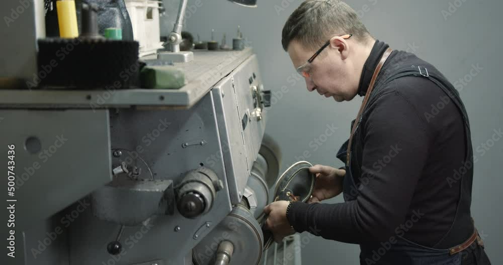 Craftsman working with shoes in a workshop Craftsman working with shoes in a workshop