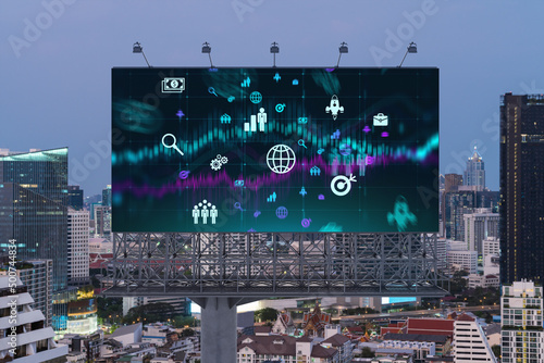 Hologram of Research and Development glowing icons on billboard. Sunset panoramic city view of Bangkok. Concept of innovative technologies to create new services and products in Southeast Asia.