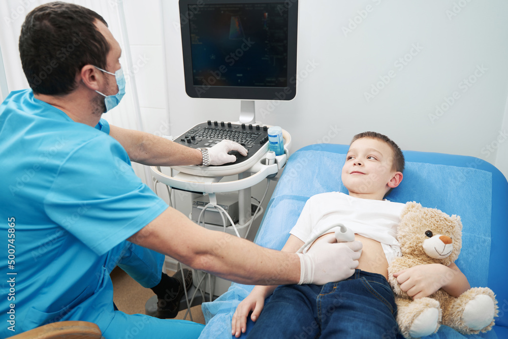 Examining of the child abdomen in the doctor office Examining of the child abdomen in the doctor office