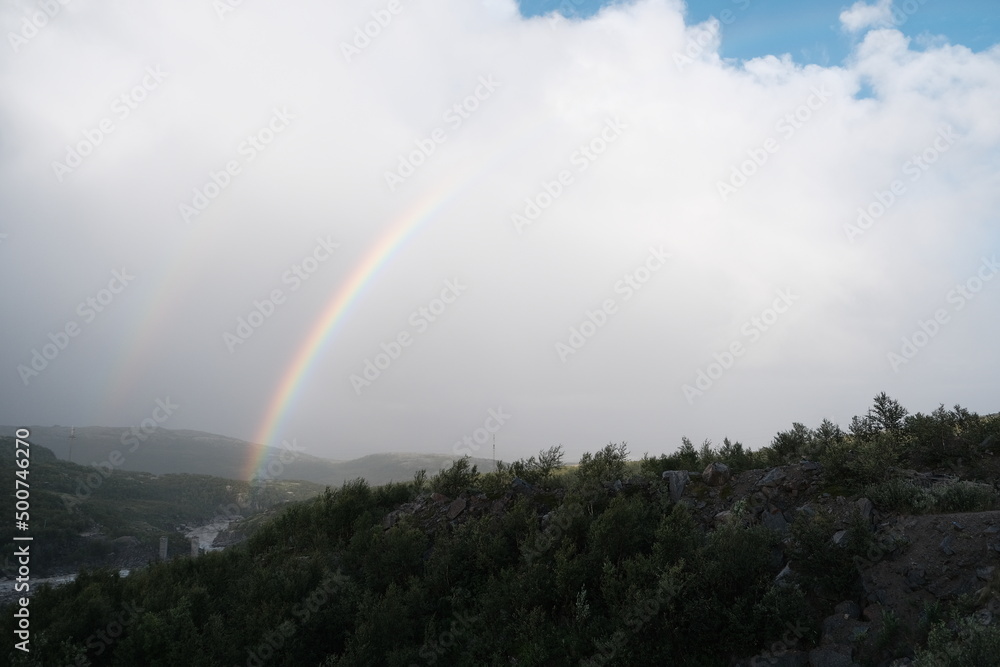 Double rainbow after rain over rocks and the Teriberka River, Murmansk region, Russia Double rainbow after rain over rocks and the Teriberka River, Murmansk region, Russia