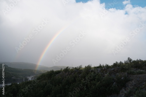 Double rainbow after rain over rocks and the Teriberka River  Murmansk region  Russia