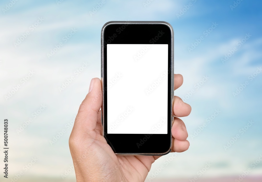 Hand holding phone with white screen on pastel background. Showing empty screen of modern cellphone.