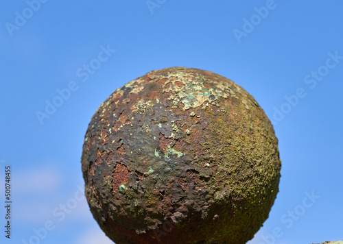 Old rusty iron ball fence ornament