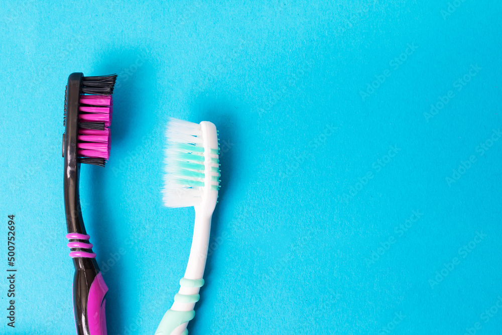 Two toothbrushes on a blue background, copy sapce Two toothbrushes on a blue background, copy sapce