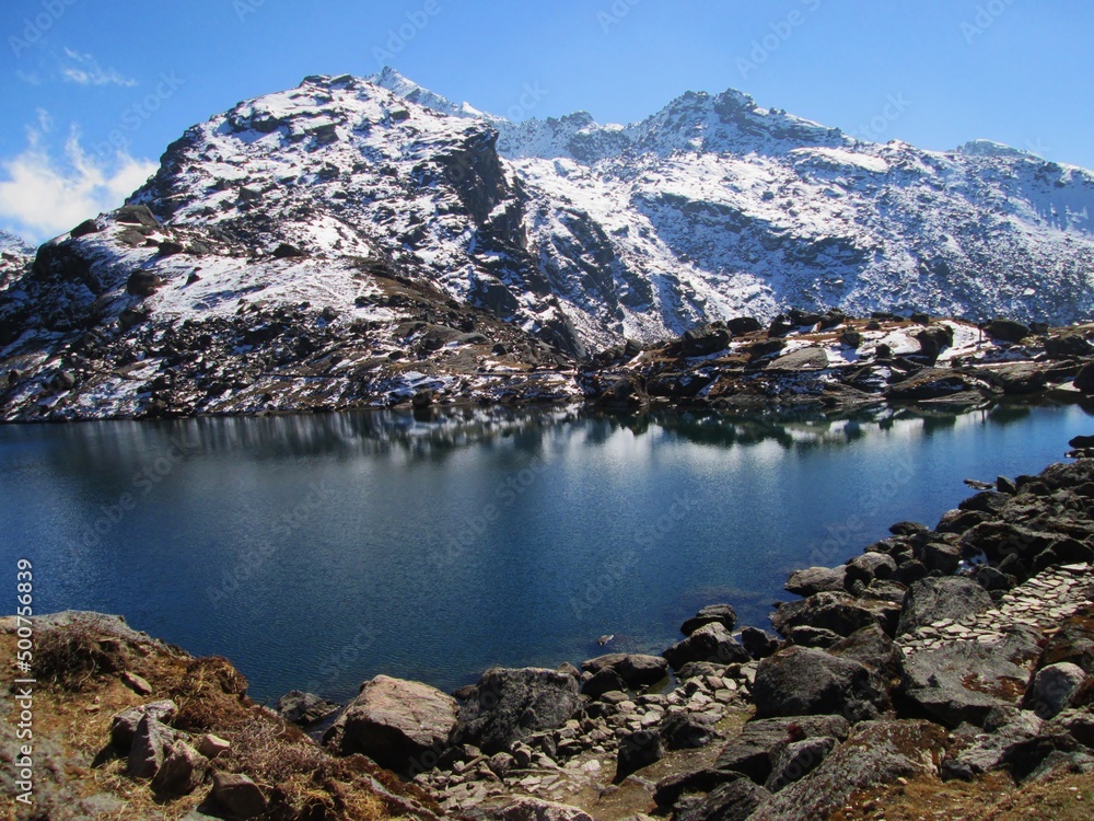 View of Gosaikunda Lake. Extreme sports in the Himalayas, Tourism in the Mountains. Snow reflection in the water. Gosainkunda in Langtang National Park, Rasuwa Disctict, Nepal
