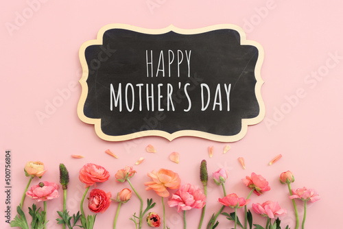 mother's day concept with pink flowers over pastel background
