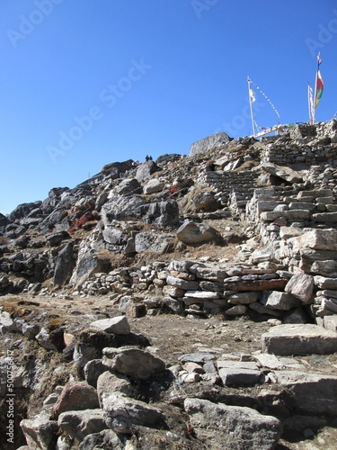 View of Rocks and Buddhist Prayer Flags on the peak next to Gosainkunda lake. Himalayas. Trekking in Nepal. Gosaikunda in Langtang National Park, Rasuwa Disctict photo