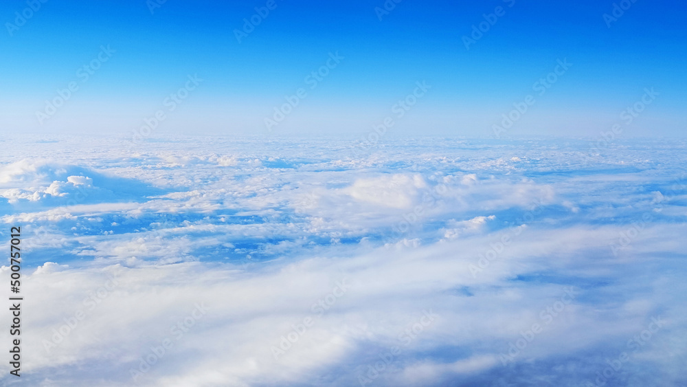 Beautiful view from the plane to the blue sky with white clouds Beautiful view from the plane to the blue sky with white clouds