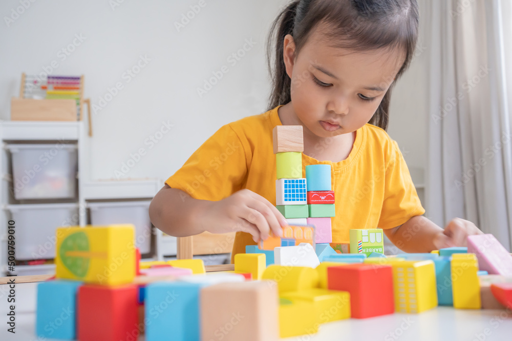 Asian baby girl playing alone. Little kid plays building blocks. Asian baby girl playing alone. Little kid plays building blocks.