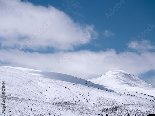 Mountains with fresh snow and blue sky with white clouds. Sierra de Guadarrama, Madrid, Spain.