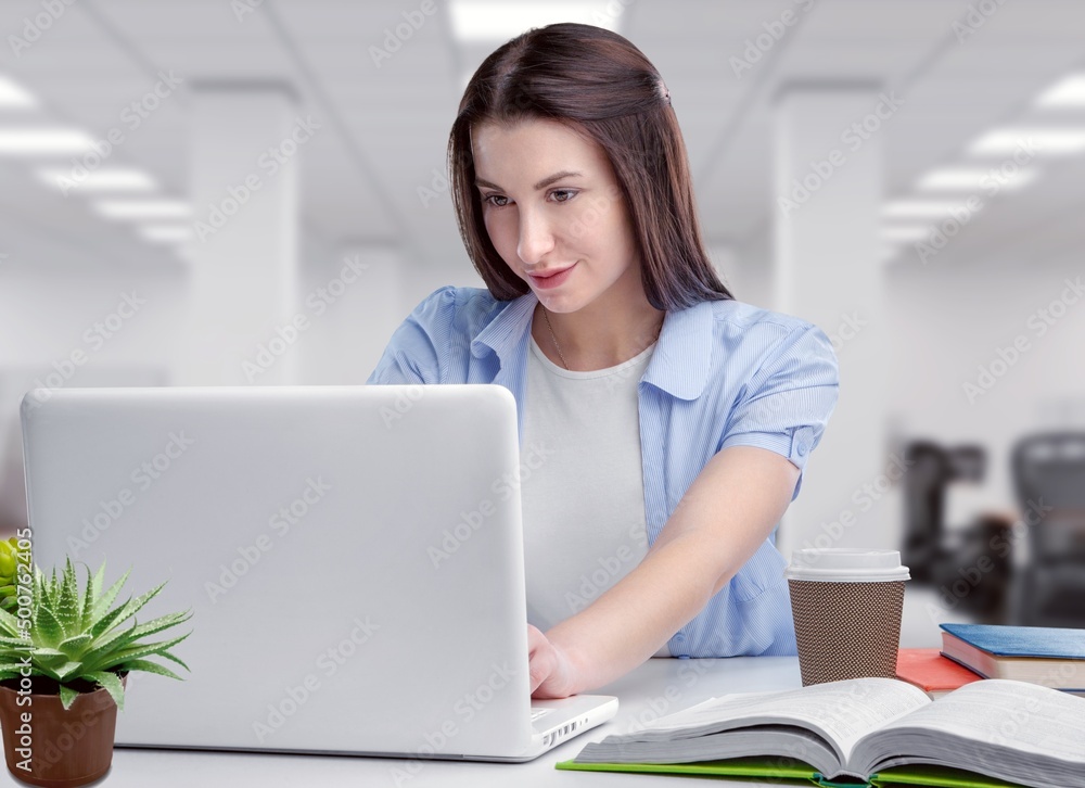 Distance Education concept. Beautiful woman working on laptop. Webinar studying online at home looking at screen Distance Education concept. Beautiful woman working on laptop. Webinar studying online at home looking at screen