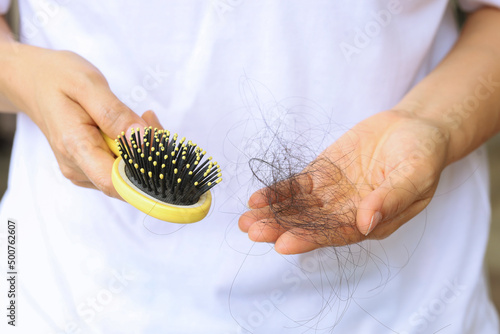 Comb with hair loss caused by stress or health problems, isolated photo on a white background.